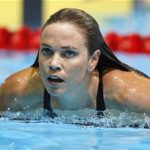 Natalie Coughlin swims from the pool after winning the women's 100m butterfly semifinal during the U.S. Olympic swimming trials in Omaha, Nebraska, June 25, 2012. REUTERS/Jeff Haynes (UNITED STATES - Tags: SPORT SWIMMING)