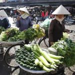 Vegetable sellers wait for customers at a market in Bao Loc city, near Vietnam's southern commercial hub Ho Chi Minh city February 23, 2011. REUTERS/Kham