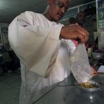 A local brings his gold for examination at a gold laboratory in the gold market in Khartoum July 15, 2012. REUTERS/Mohamed Nureldin Abdallah