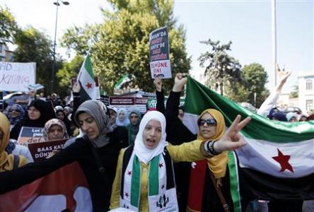 Syrians living in Turkey shout slogans during a protest against the government of Syrian President Bashar al-Assad, in Istanbul Syrians living in Turkey shout slogans during a protest against the government of Syrian President Bashar al-Assad, in Istanbul July 14, 2012. REUTERS/Osman Orsal
