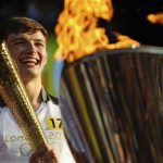 Torchbearer Tyler Rix smiles after lighting the Olympic Cauldron during the Olympic torch relay celebrations in Hyde Park, London July 26, 2012. REUTERS/ Ki Price