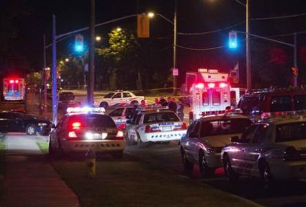 Police cars are seen at a crime scene following a shooting in Scarborough, a suburb in east Toronto, July 17, 2012. REUTERS/Mark Blinch