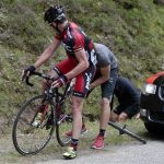 BMC Racing Team rider Cadel Evans of Australia receives assistance after a flat tyre during the 14th stage of the 99th Tour de France cycling race between Limoux and Foix, July 15, 2012. REUTERS/Fred Mons/Pool