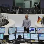 Traders work at their desks at the Frankfurt stock exchange July 2, 2012. REUTERS/Alex Domanski
