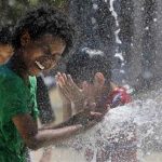 Aziz Taylor, 11 years old, of Washington DC, plays in a water fountain to beat the heat gripping the nation's capital while in the Capital Heights neighborhood of Washington, July 2, 2012. REUTERS/Larry Downing