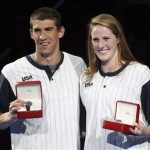 Michael Phelps (L) and Missy Franklin (R) pose with watches given to them as the best performers at the U.S. Olympic swimming trials, in Omaha, Nebraska, July 2, 2012. REUTERS/Jeff Haynes