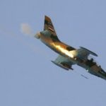 A Syrian fighter plane fires a rocket during an air strike in the village of Tel Rafat,