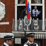 Wikileaks founder Julian Assange gestures as he speaks from the balcony of Ecuador's embassy, where he is taking refuge in London August 19, 2012. REUTERS/Chris Helgren