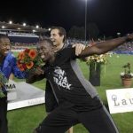 Jamaica's Usain Bolt celebrates with his compatriot Yohan Blake (L) during the Athletissima Diamond League meeting in Lausanne August 23, 2012. REUTERS/Denis Balibouse