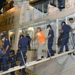 Chinese activists arrested on suspicion of violating the Immigration Control and Refugee Recognition Law at a disputed island in the East China Sea, known as Senkaku in Japan or Diaoyu in China, are escorted by Japan Coast Guard crew members as they disembark from a Japan Coast Guard patrol ship at a port in Naha on the southern Japanese island of Okinawa, in this photo taken by Kyodo August 16, 2012. REUTERS/Kyodo
