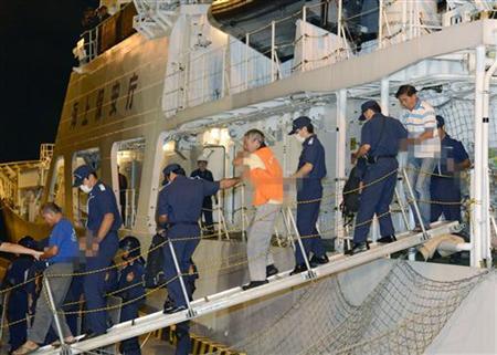 Chinese activists arrested on suspicion of violating Immigration Control and Refugee Recognition Law at disputed island in East China Sea, known as Senkaku in Japan or Diaoyu in China, escorted by Japan Coast Guard crew as they disembark in Naha Chinese activists arrested on suspicion of violating the Immigration Control and Refugee Recognition Law at a disputed island in the East China Sea, known as Senkaku in Japan or Diaoyu in China, are escorted by Japan Coast Guard crew members as they disembark from a Japan Coast Guard patrol ship at a port in Naha on the southern Japanese island of Okinawa, in this photo taken by Kyodo August 16, 2012. REUTERS/Kyodo
