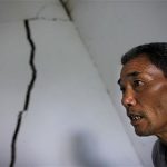 Ma Tianxin looks at the cracked walls of his house after a landslide near Badong, on the banks of the Yangtze River, 100km (62 miles) from the Three Gorges dam in Hubei province August 7, 2012. China relocated 1.3 million people during the 17 years it took to complete the Three Gorges dam. Even after finishing the $59 billion project last month, the threat of landslides along the dam's banks will force tens of thousands to move again. It's a reminder of the social and environmental challenges that have dogged the world's largest hydroelectric project. While there has been little protest among residents who will be relocated a second time, the environmental fallout over other big investments in China has become a hot-button issue ahead of a leadership transition this year. Picture taken on August 7, 2012. To match story CHINA-THREEGORGES/ REUTERS/Carlos Barria