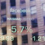 The falling price of Facebook's stock is seen on a screen reflected in the window of the Nasdaq building in New York August 16, 2012. REUTERS/Lucas Jackson
