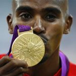 Britain's Mo Farah kisses his gold medal for the men's 5000m at the victory ceremony at the London 2012 Olympic Games at the Olympic Stadium August 11, 2012. REUTERS/Eddie Keogh