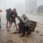 People try to get a look at the high surf along Beach Blvd. as Hurricane Isaac passes through Gulfport, Mississippi, August 29, 2012. REUTERS/Michael Spooneybarger
