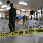 A policeman walks from the scene of an explosion inside the God's House Of Miracles International Church after a grenade attack in Nairobi April 29, 2012. REUTERS/Thomas Mukoya