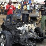 Part of a car used for detonating a bomb is seen at the scene of a blast in Nigeria's northern city of Kaduna April 8, 2012. REUTERS/Stringer