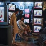 Shopkeepers gather around television screens showing a speech by U.S. President Barack Obama as he announced the death of al Qaeda leader Osama bin Laden at a market in Quetta May 2, 2011. REUTERS/Naseer Ahmed
