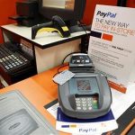 A sign showing customers' ability to now pay with their PayPal account sits at a cashier station at a Home Depot store in Daly City, California, February 21, 2012. REUTERS/Beck Diefenbach