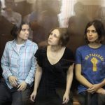 Members of the female punk band "Pussy Riot" (R-L) Nadezhda Tolokonnikova, Maria Alyokhina and Yekaterina Samutsevich sit in a glass-walled cage during a court hearing in Moscow, August 17, 2012. A Russian judge delivers a verdict on Friday against three members of the Pussy Riot punk band whose trial for staging an anti-Kremlin protest in a church has provoked an international outcry against President Vladimir Putin. REUTERS/Sergei Karpukhin