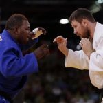 Democratic Republic of Congo's Cedric Mandembo (L) fights with Russia's Alexander Mikhaylin during their men's +100kg elimination round of 32 judo match at the London 2012 Olympic Games August 3, 2012. REUTERS/Toru Hanai