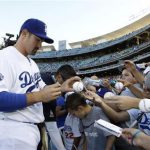 Newly acquired Los Angeles Dodgers first baseman Adrian Gonzalez signs autographs for fans before their MLB baseball game against Miami Marlins in Los Angeles August 25, 2012. REUTERS/Danny Moloshok