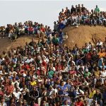 Mining community gathers at a hill dubbed the "Hill of Horror" during a memorial service for miners killed during clashes at Lonmin's Marikana platinum mine in Rustenburg, 100 km (62 miles) northwest of Johannesburg, August 23, 2012. REUTERS/Siphiwe Sibeko