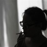 A woman smokes a cigarette in Los Angeles, California, May 31, 2012. REUTERS/Jonathan Alcorn