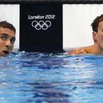 Michael Phelps (L) and Ryan Lochte of the U.S. check their times after their men's 200m individual medley semi-final during the London 2012 Olympic Games at the Aquatics Centre August 1, 2012. REUTERS/David Gray