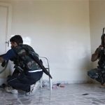 Members of the Free Syrian Army take cover inside a house during clashes with Syrian army soldiers in Aleppo's Saif al-Dawla district, August 22, 2012. REUTERS/Zain Karam