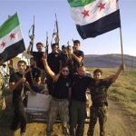 Members of Free Syrian Army fighters holding their weapons and opposition flags are pictured at Sermada near Idlib August 12, 2012. Picture taken August 12, 2012. REUTERS/Shaam News Network/Handout