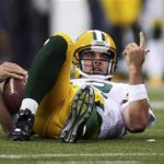 Green Bay Packers quarterback Aaron Rodgers (12) lays on the ground after being sacked by Seattle Seahawks defensive end Chris Clemons during the second quarter of their Monday night NFL football game at Centurylink Field in Seattle, Washington, September 24, 2012. REUTERS/Anthony Bolante
