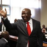 South African former African National Congress (ANC) Youth League leader Julius Malema waves to his supporters during his court appearance in Polokwane, 350 km (220 miles) north of Johannesburg, September 26, 2012. A South African court charged Malema, a renegade of the ruling ANC and opponent of President Jacob Zuma, with money laundering on Wednesday. Prosecutors did not file any other charges. REUTERS/Siphiwe Sibeko