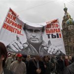 People hold a banner, displaying an image of Russia's President Vladimir Putin, during the "March of Millions" protest rally, held by opposition supporters, near the Church of the Savior on Spilled Blood in St. Petersburg, September 15, 2012. Protesters chanting "Russia without Putin" began marching through Moscow on Saturday in a protest seen as a test of the opposition's ability to mount a sustained challenge to President Vladimir Putin. The banner reads "Prices and tariffs increase, poverty. Friend, that was you who chose it all!". REUTERS/Alexander Demianchuk