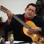 Venezuelan President Hugo Chavez plays a guitar, which was a gift from Mexican singer Vicente Fernandez, during a cabinet meeting at Miraflores Palace in Caracas September 20, 2012. REUTERS/Miraflores Palace