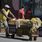 A man with a private license to sell vegetables pushes his cart on a street in Havana February 29, 2012. REUTERS/Enrique de la Osa