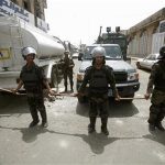 Riot policemen stand guard outside the French embassy in Sanaa September 20, 2012. REUTERS/Khaled Abdullah