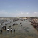 Demonstrators stand in the waters of the Bay of Bengal as they shout slogans during a protest near Kudankulam nuclear power project in the southern Indian state of Tamil Nadu September 13, 2012. REUTERS/Adnan Abidi