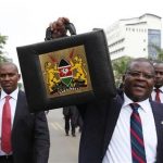 Kenya's Finance Minister Robinson Githae displays the briefcase containing his speech as he walks to present the budget to the parliament in the capital Nairobi June 14, 2012. REUTERS/Noor Khamis