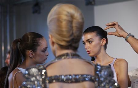 Model has her hair styled before a reception on the eve of London Fashion Week A model has her hair styled before a reception on the eve of London Fashion Week September 13, 2012. The reception was for Livia Firth's Green Cut initiative to promote environmentally sustainable fashion. REUTERS/Suzanne Plunkett