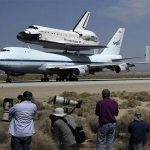 Photographers take photos of the Space Shuttle Endeavour carried piggyback atop a Boeing 747 jumbo jet, making its last and final landing at Edwards Air Force Base in California, September 20, 2012, after a cross-country trip to Los Angeles to begin its final mission as a museum exhibit. REUTERS/Gene Blevins