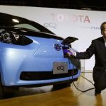 Toyota Motor Corp's Executive Vice President Takeshi Uchiyamada poses next to the company's newly developed compact electric vehicle eQ after a news conference in Tokyo September 24, 2012. REUTERS/Yuriko Nakao