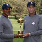 U.S. captain Davis Love III poses with Tiger Woods and the Ryder Cup during the 39th Ryder Cup golf matches at the Medinah Country Club in Medinah, Illinois, September 25, 2012. REUTERS/Jeff Haynes