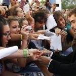 U.S. actor Zac Efron signs autographs as he arrives on the red carpet for the world premiere of his movie "At Any Price" at the 69th Venice Film Festival in Venice August 31, 2012. REUTERS/Max Rossi