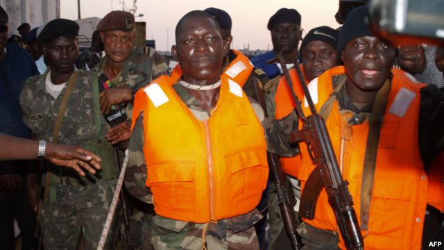 Guinea Bissau soldiers escort Captain Pansau N'Tchama (C), accused of being the mastermind behind the October 21 attack on an elite army barracks, shortly after his arrest in Bolama, on October 27, 2012