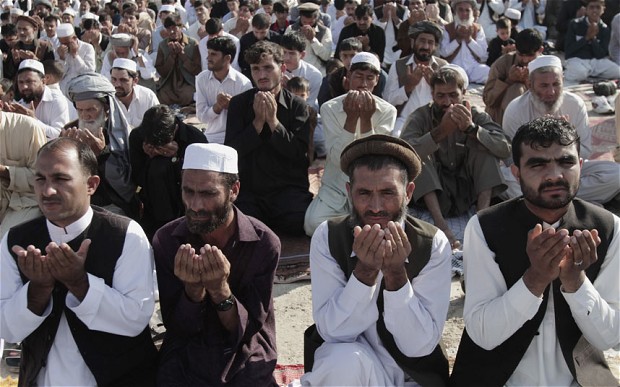 Afghans offer Eid al-Adha prayers outside a mosque in the outskirt of Jalalabad east of Kabul, Afghanistan