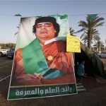 A Libyan loyal to Libya's leader Muammar Gaddafi sits inside a tent in front of Bab Al-Aziziyah, Gaddafi's heavily fortified compound, in Tripoli March 27, 2011. REUTERS/Zohra Bensemra