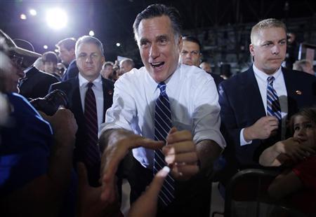 Republican presidential candidate Romney greets audience members at a campaign rally in Denver