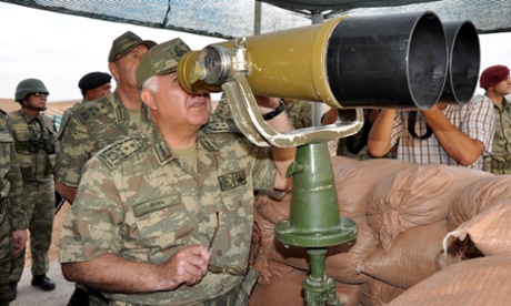 Turkey's chief of the general staff, Necdet Ozel, inspects troops along the border with Syria