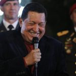 Venezuela's President and presidential candidate Hugo Chavez smiles as he addresses the media at the Miraflores Palace in Caracas October 6, 2012. REUTERS/Tomas Bravo